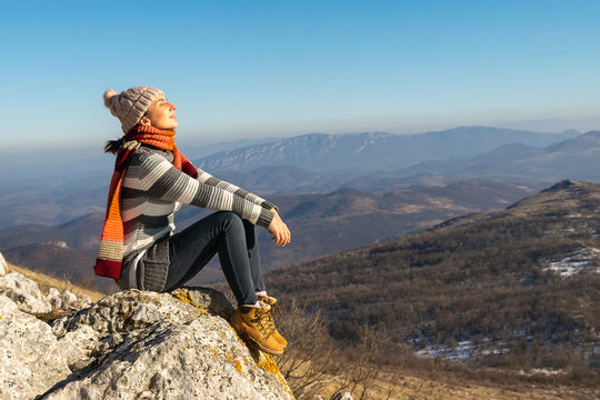 Woman sunbathing on mountain cliff on Rtanj mountain in Serbia - Powered by Adobe