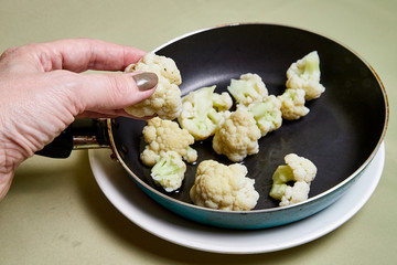Cooking. Broccoli on a pan on a light background