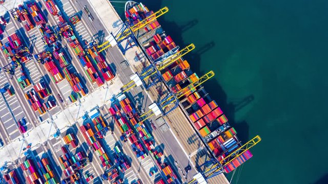 Container ship loading and unloading in deep sea port, Aerial view circle container shipyard business logistic import and export cargo freight ship, transportation by container ship in open sea.
