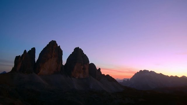 Tre Cime di Lavaredo / Drei Zinnen, three distinctive mountain peaks in the Sexten Dolomites at sunset in autumn, South Tyrol, Italy