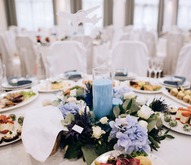 elegant wedding table setting with flowers and blue  candle