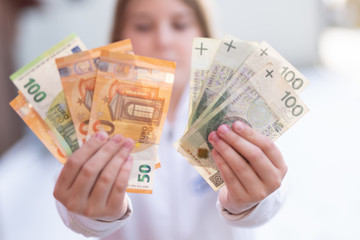 mix of zloty polish currency cash bank notes exchange rates against euro money - obrazy, fototapety, plakaty