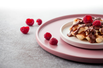 Belgian waffle with chocolate and raspberries