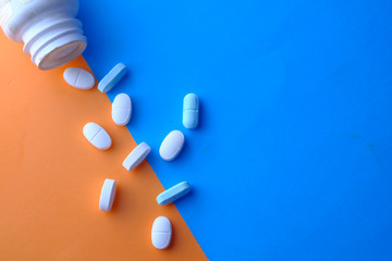 top view of pill spilling from container 