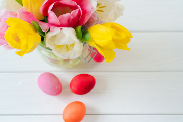 Fresh spring flowers with painted eggs for Easter celebration
