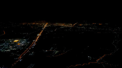 A view looking down on the city from the air at night plane thailand,There is little noise