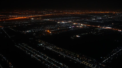 A view looking down on the city from the air at night plane thailand,There is little noise