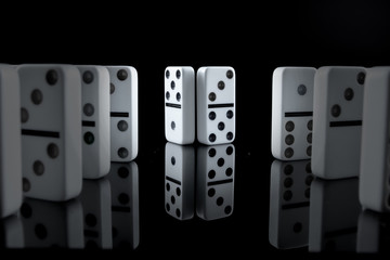 White dominoes in the dark close up