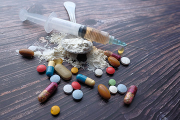 drug abuse concept with pill and syringe 