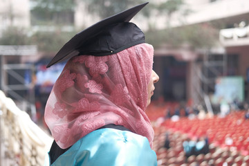 Close up of muslim women wearing graduation hat 