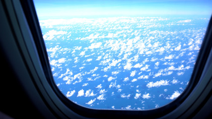 Fototapeta premium The airplane window is travelling on sky