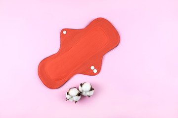 Reusable cotton cloth woman pad on pink background. Top view.