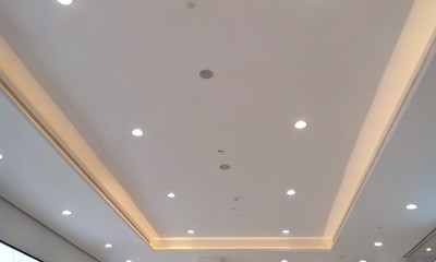 Decor Gypsum false ceiling and finishes in a shopping mall interior finishes painted with White emulsion paint with decorative down lights to make beautiful ceiling view design