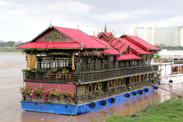 Walking red house-ship on the Mekong River