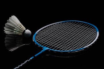 Badminton shuttlecock and badminton racket in the black background used in competition
