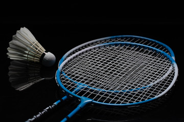 Badminton shuttlecock and badminton racket in the black background used in competition