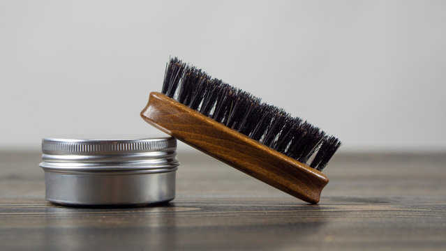 Beard Brush And Wax Jar for Beard And Mustache On A Wooden Table. Barber Accessories. High Quality Photo