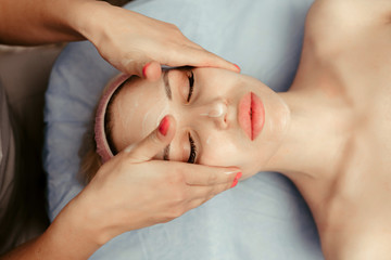 face massage on woman in the spa salon