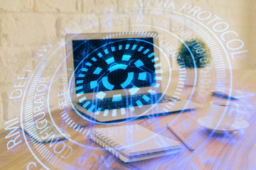 Double exposure of laptop computer and technology theme hologram. Concept of freelance work.