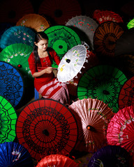 Burmese girl painting parasols