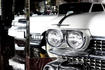 Reflection 1959 white retro car in the mirrors