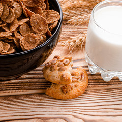 A healthy breakfast. Cereals are at the black plate on the wood background