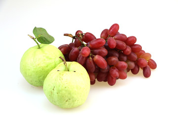 Two guava and red grapes  white background