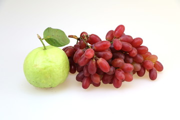 Two guava and red grapes  white background
