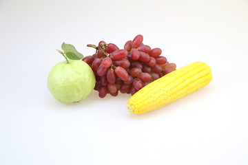 Fresh fruit (guava, corn and grapes) white background