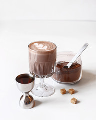 Cocoa in a glass glass on a white table.