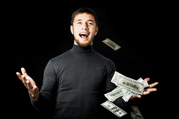 the man is a Businessman with his hands spread under a lot of falling banknotes