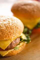 Tasty grilled home made burger cooking with beef, tomato, cheese, cucumber and lettuce. 