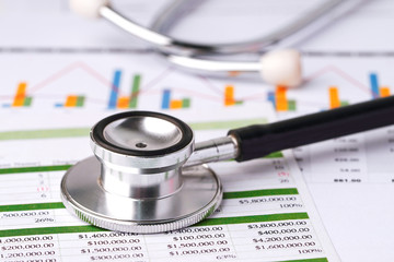 Stethoscope on charts and graphs spreadsheet paper, Finance, Account, Statistics, Investment, Analytic research data economy and Business company concept.