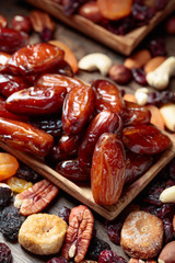 Various dried fruits and nuts in wooden dish.