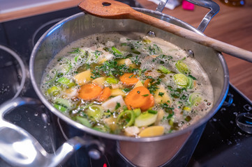 Stew with fresh vegetables cooks in a saucepan