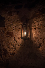 Candle lantern by a stone masonry wall