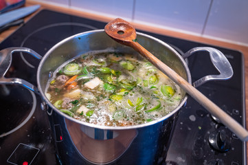 Stew with fresh vegetables cooks in a saucepan