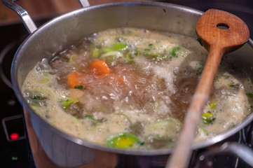 Stew with fresh vegetables cooks in a saucepan