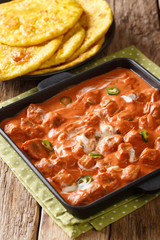 Indian cuisine Tofu Butter Masala Panner with roti closeup in a pan. vertical