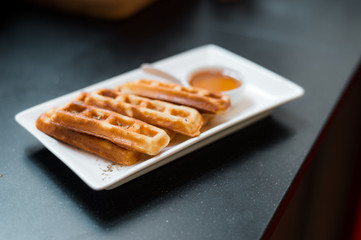homemade waffles stick with maple syrup in mini cafe