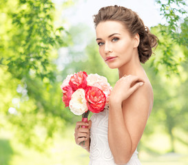 wedding and people concept - beautiful young woman or bride with bouquet of flowers over green...
