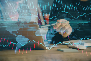 Forex graph with businessman typing on computer in office on background. Concept of analysis....