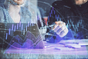 Forex graph with businessman typing on computer in office on background. Concept of analysis. Double exposure.