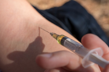 hand with syringe
