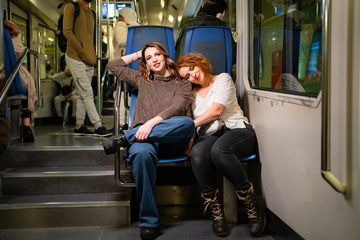 Two girls friends go in the subway or on the funicular