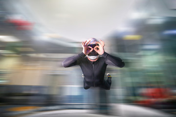 Image. Picture of a flying man. Skydiver hovers in the wind tunnel. Extreme hobby without age restrictions.
