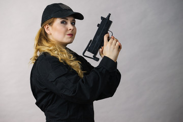 Woman holds gun in hands.