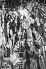 Dreamcatcher, boho chic feathers, ethnic amulet, symbol. With beads of rope hanging. Talisman for a dream. Witchcraft and secrets. Witchcraft and fortune telling