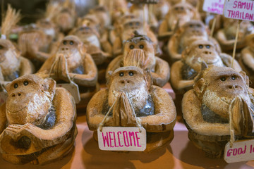 Coconut figurine or doll in the form of a monkey who invites to Koh Samui in Thailand. Travel souvenir gift