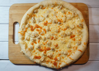 homemade pizza from the oven on a cutting board on the table
